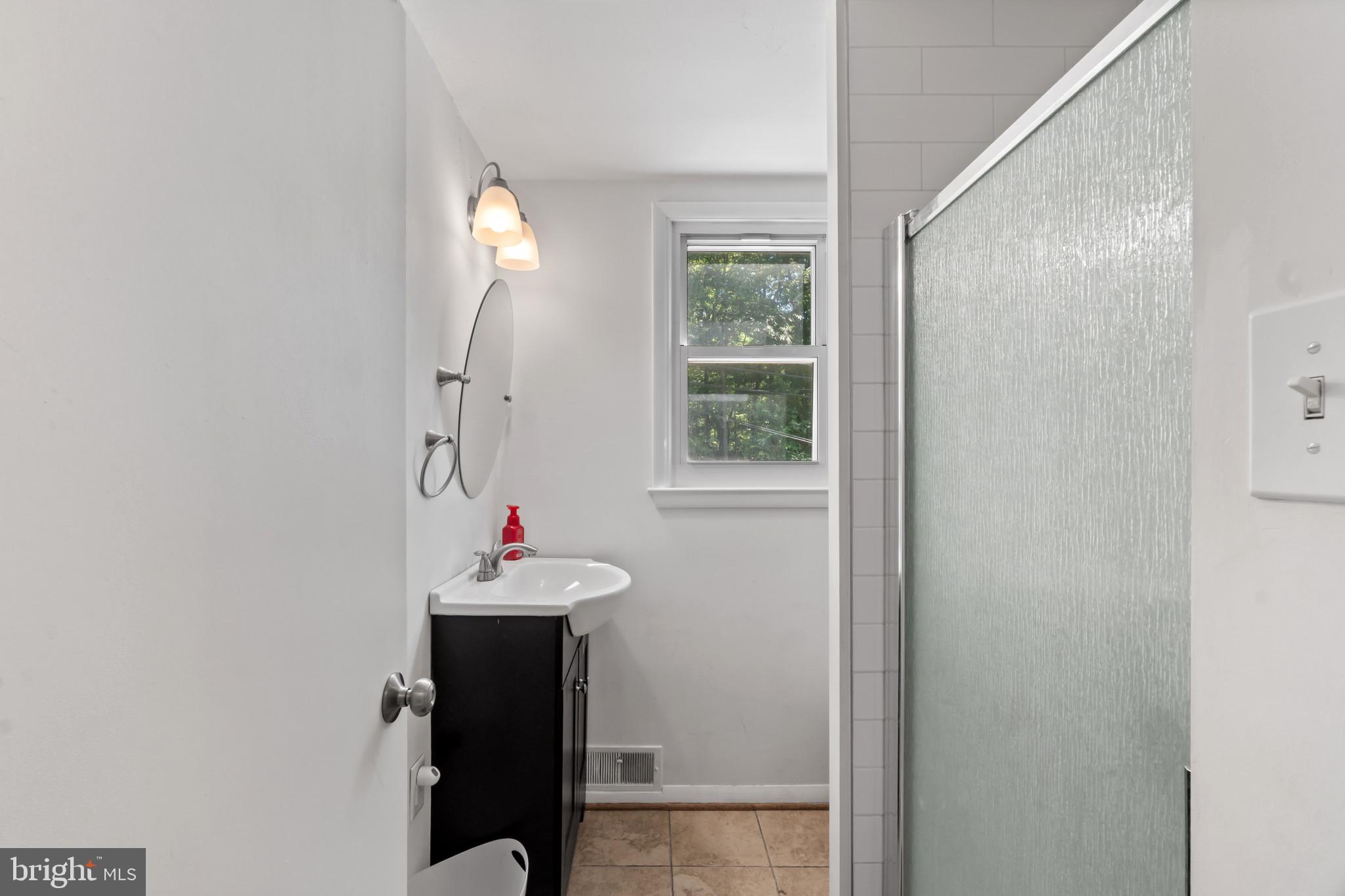 415 Baylor Road Glen Burnie, MD 21061 - Photo 18 of 29 a bathroom with a sink mirror and vanity