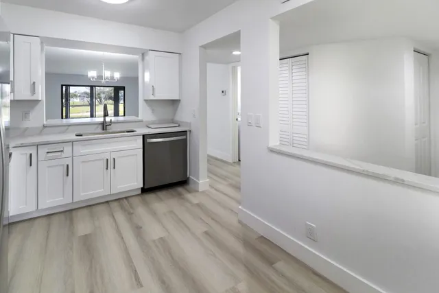 a spacious bathroom with a granite countertop sink and a mirror