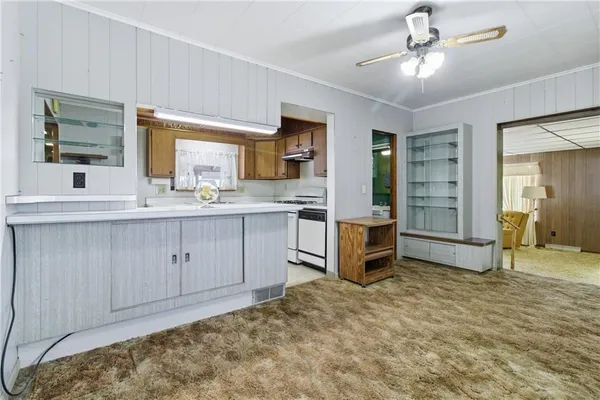 a kitchen with a stove a sink and a refrigerator