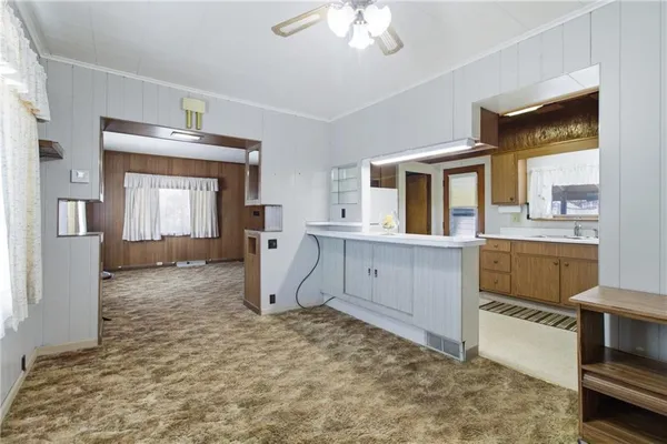 a view of a kitchen with a sink and cabinets