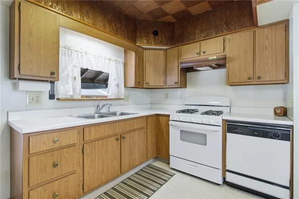 a kitchen with a sink stove and cabinets