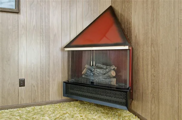 a room with water heater and wooden walls