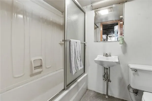 a bathroom with a bathtub sink and mirror