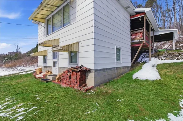a view of a house with a yard and sitting area