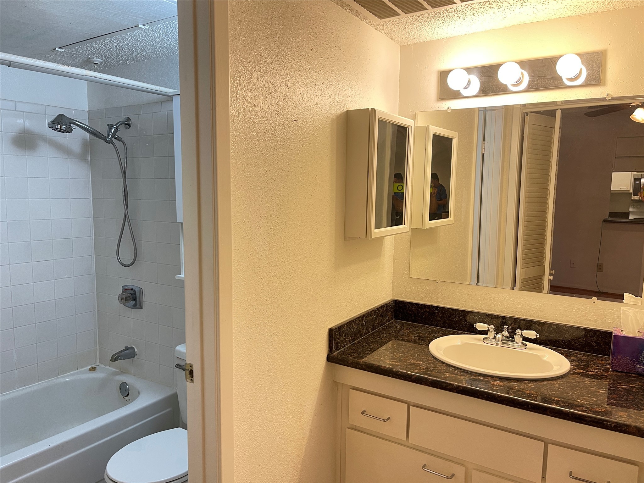 2800 Jeanetta Street, Unit 2204 Houston, TX 77063 - Photo 17 of 28 a bathroom with a granite countertop sink and a mirror