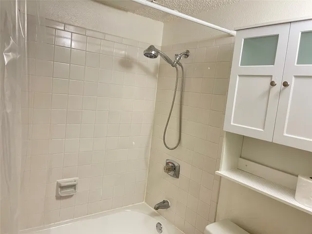 a bathroom with a shower and toilet