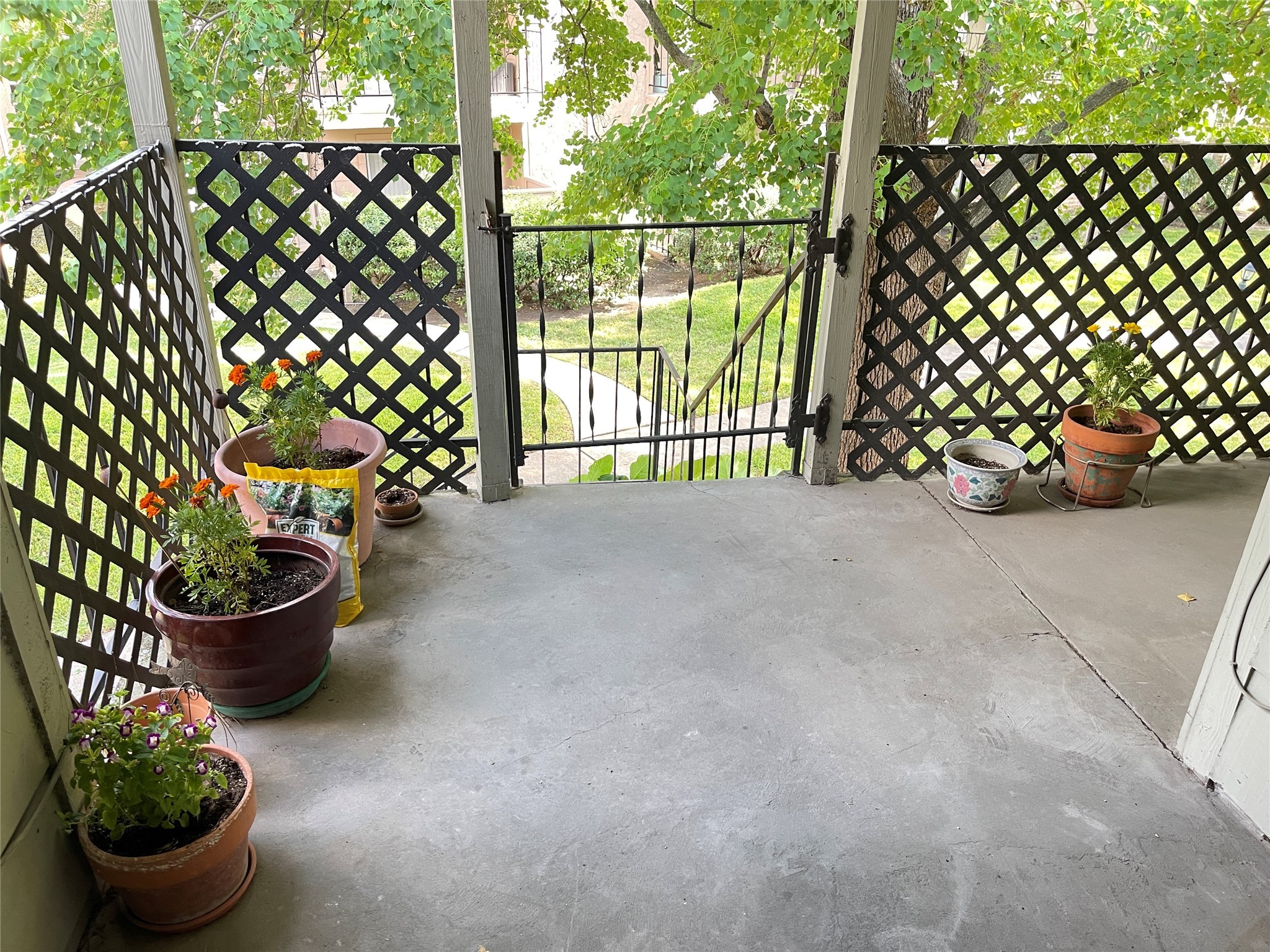 2800 Jeanetta Street, Unit 2204 Houston, TX 77063 - Photo 21 of 28 a view of a balcony with chair and potted plant