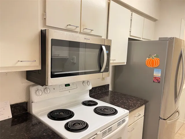 a kitchen with a sink a stove and cabinets
