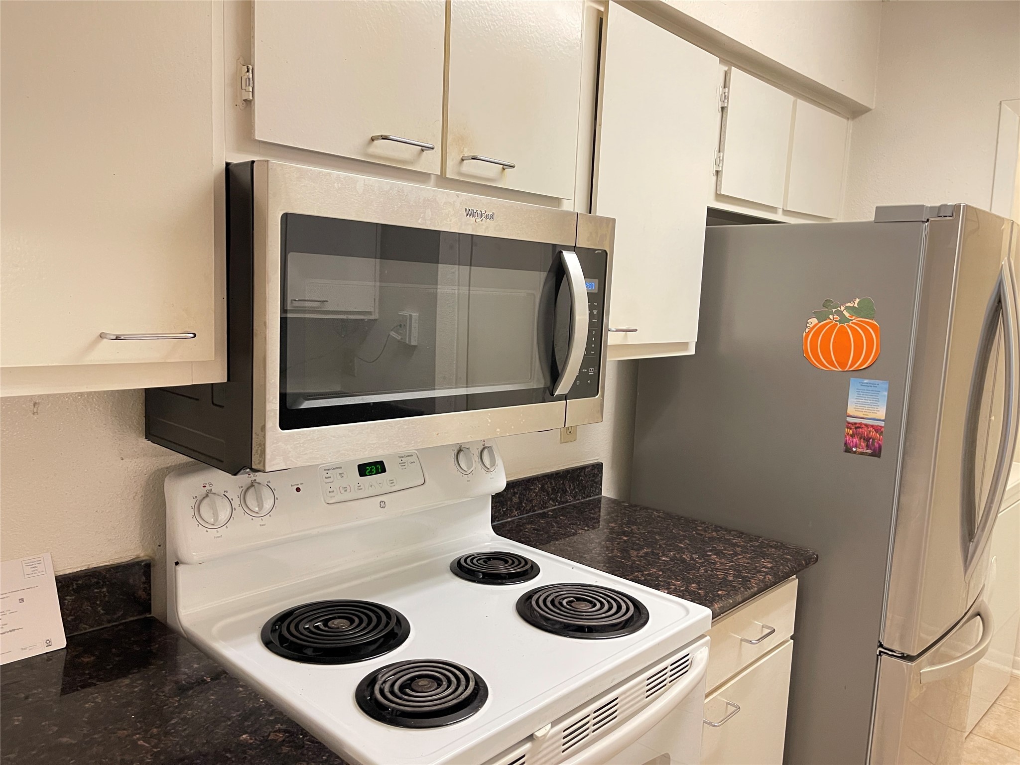 2800 Jeanetta Street, Unit 2204 Houston, TX 77063 - Photo 4 of 28 a kitchen with a sink a stove and cabinets