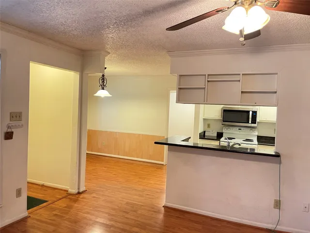 a kitchen with stainless steel appliances a sink and a microwave