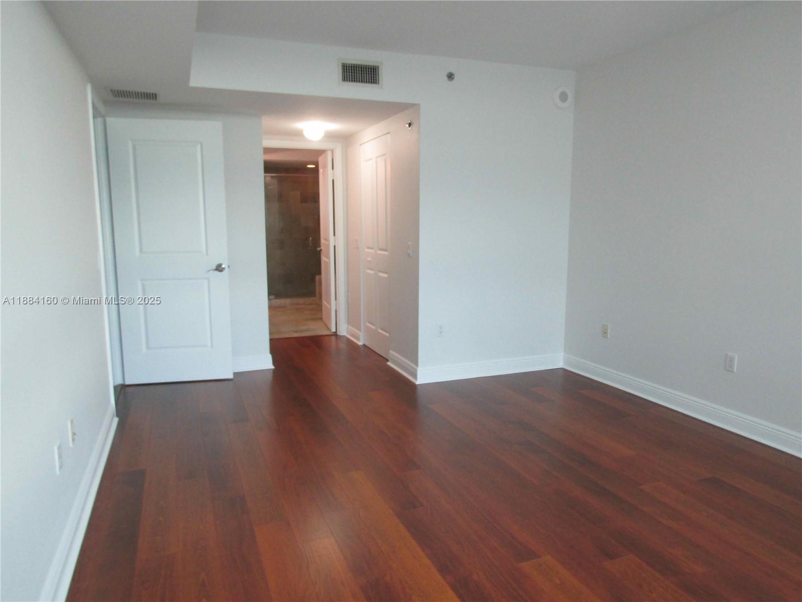 2641 North Flamingo Road, Unit 1705N Sunrise, FL 33323 - Photo 13 of 56 a view of a room with wooden floor and white walls