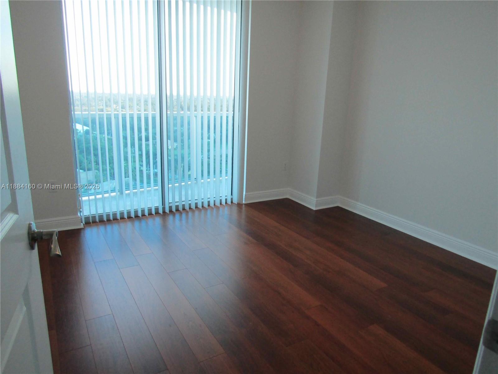 2641 North Flamingo Road, Unit 1705N Sunrise, FL 33323 - Photo 15 of 56 an empty room with wooden floor and windows