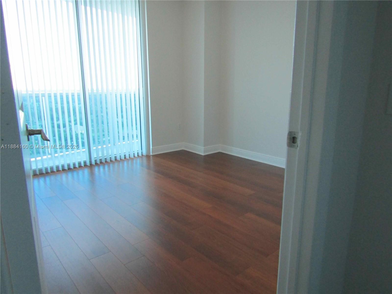 2641 North Flamingo Road, Unit 1705N Sunrise, FL 33323 - Photo 16 of 56 an empty room with wooden floor and windows