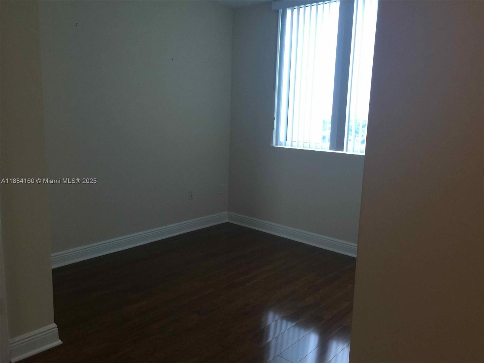 2641 North Flamingo Road, Unit 1705N Sunrise, FL 33323 - Photo 19 of 56 an empty room with wooden floor and windows