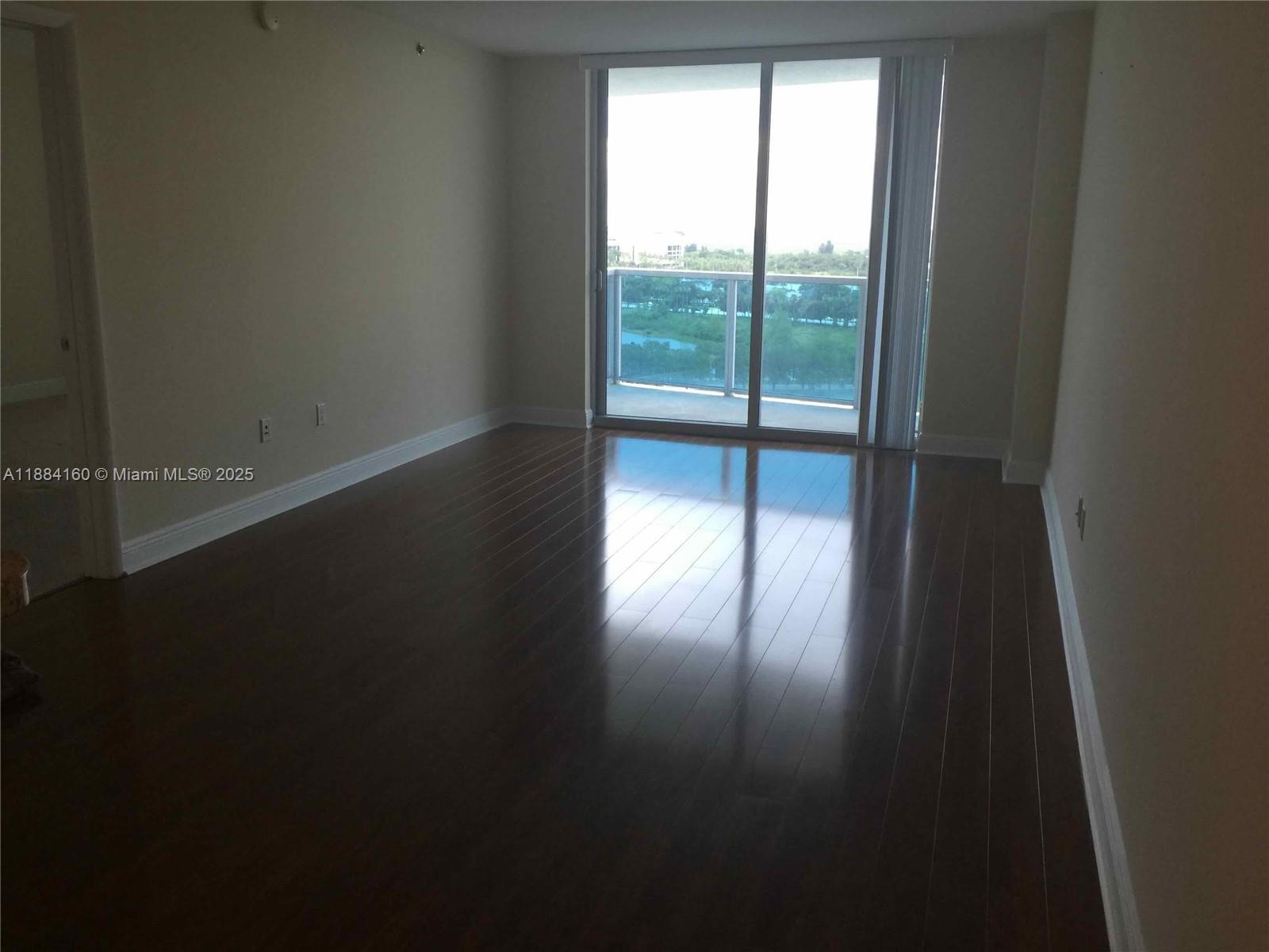 2641 North Flamingo Road, Unit 1705N Sunrise, FL 33323 - Photo 20 of 56 a view of empty room with wooden floor and fan