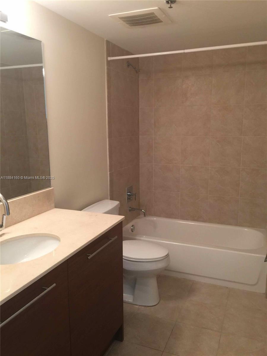 2641 North Flamingo Road, Unit 1705N Sunrise, FL 33323 - Photo 22 of 56 a bathroom with a sink a toilet and a bathtub