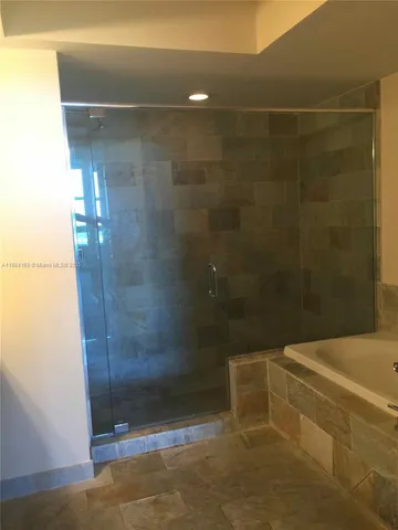 a bathroom with a toilet and a bathtub