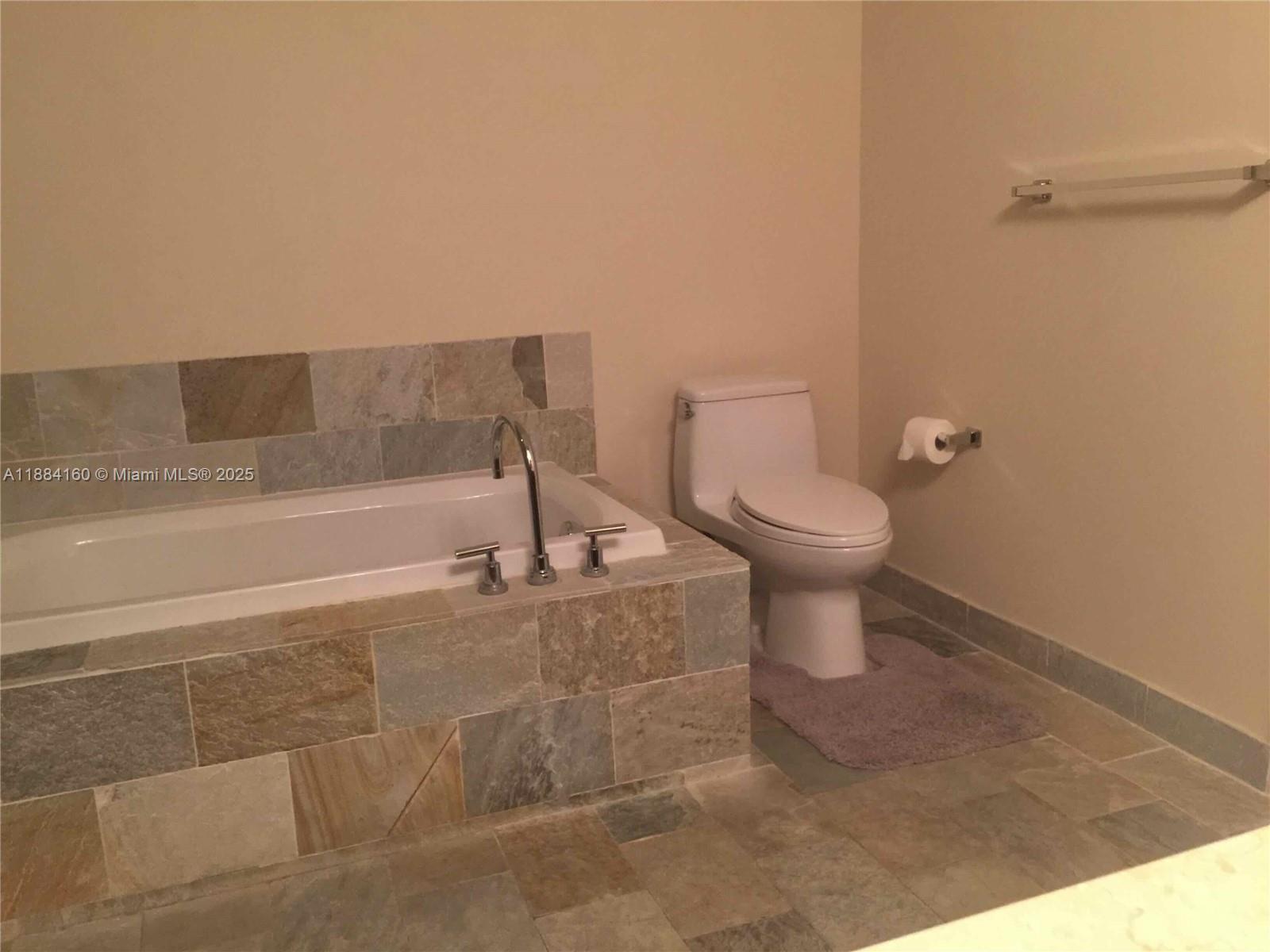 2641 North Flamingo Road, Unit 1705N Sunrise, FL 33323 - Photo 27 of 56 a bathroom with a toilet and a bathtub