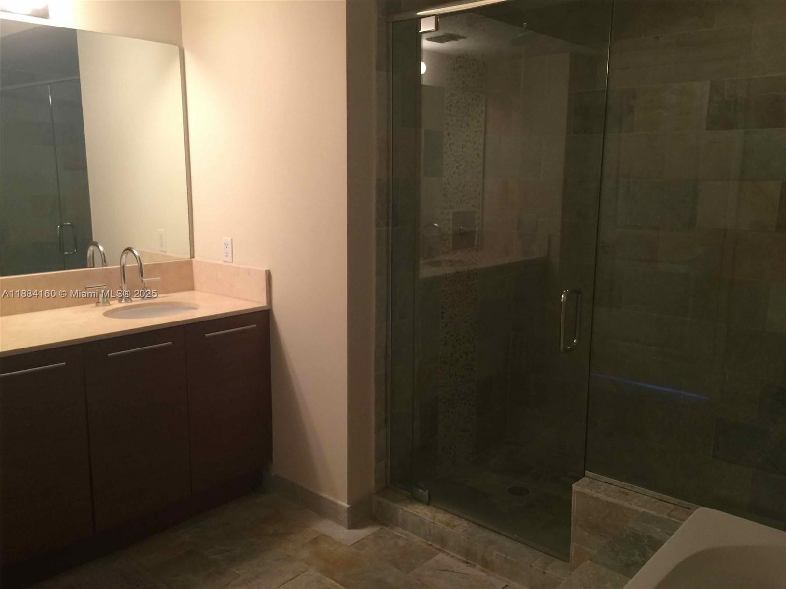 2641 North Flamingo Road, Unit 1705N Sunrise, FL 33323 - Photo 29 of 56 a bathroom with a sink and mirror