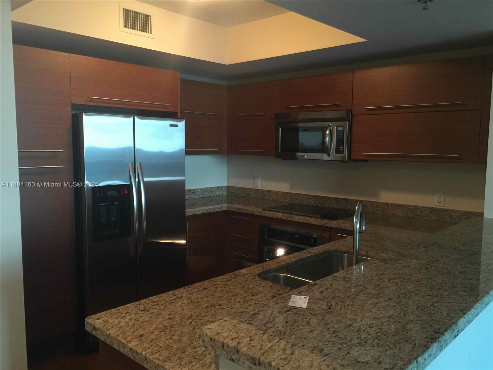 2641 North Flamingo Road, Unit 1705N Sunrise, FL 33323 - Photo 3 of 56 a room with table and stainless steel appliances