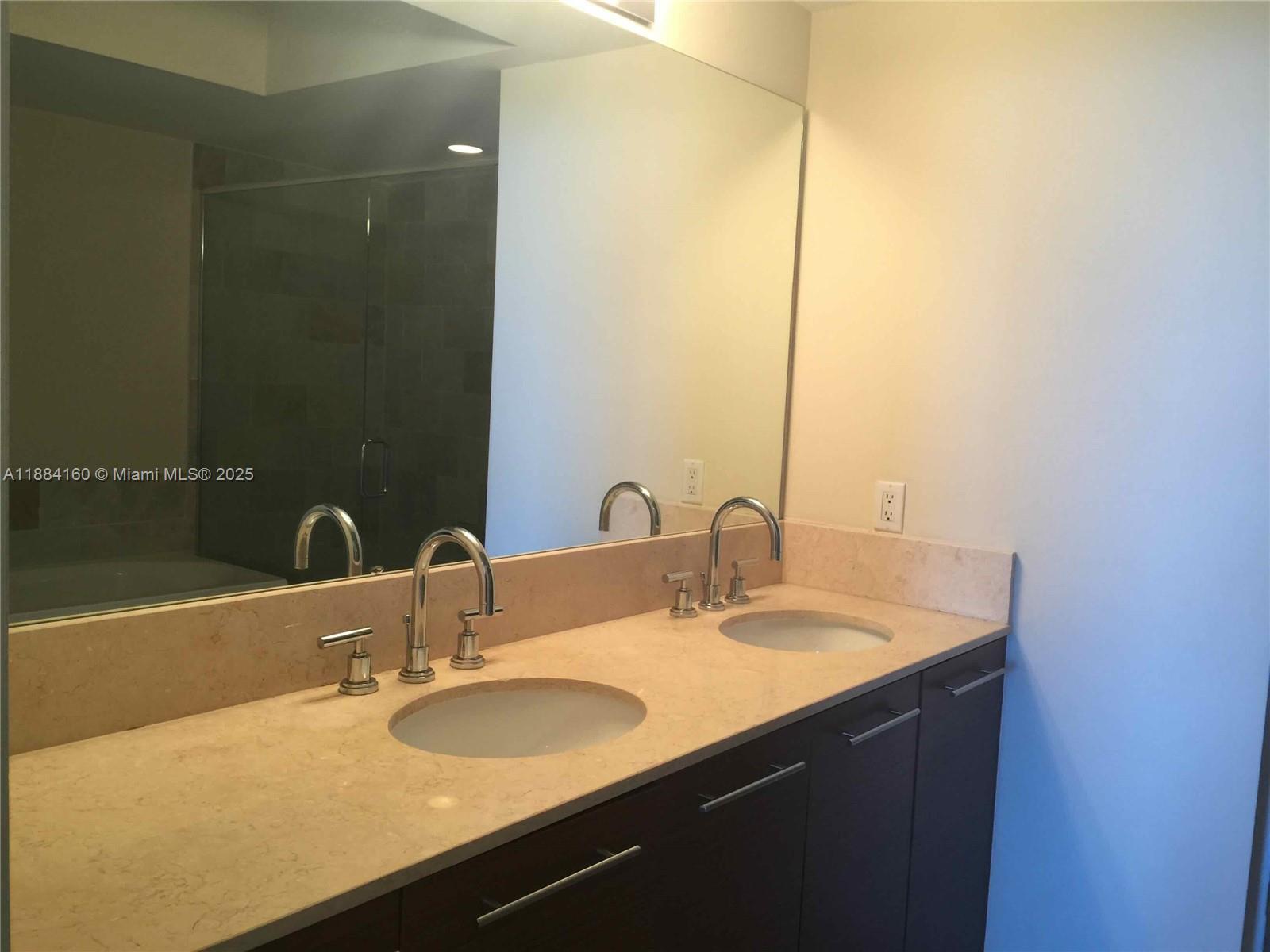 2641 North Flamingo Road, Unit 1705N Sunrise, FL 33323 - Photo 39 of 56 a bathroom with a sink and a mirror