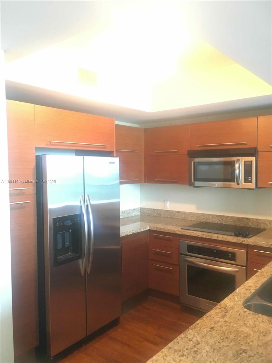 2641 North Flamingo Road, Unit 1705N Sunrise, FL 33323 - Photo 5 of 56 a kitchen with cabinets and stainless steel appliances