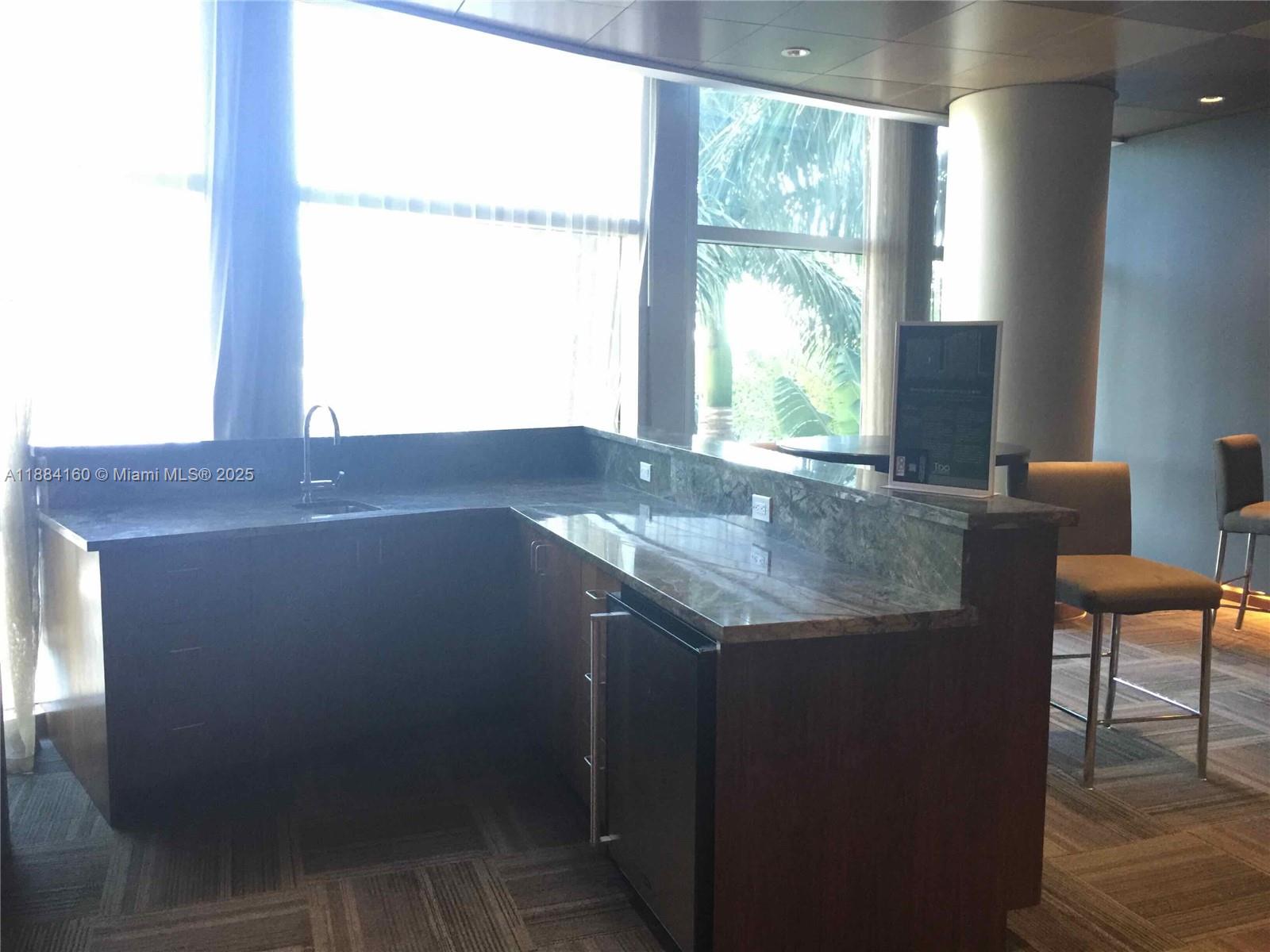 2641 North Flamingo Road, Unit 1705N Sunrise, FL 33323 - Photo 52 of 56 a view of kitchen with granite countertop window and dining table