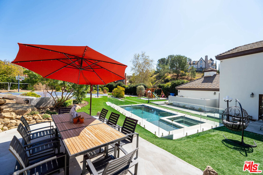 129 Saddlebow Road Bell Canyon, CA 91307 - Photo 20 of 39 an outdoor space with furniture and umbrella