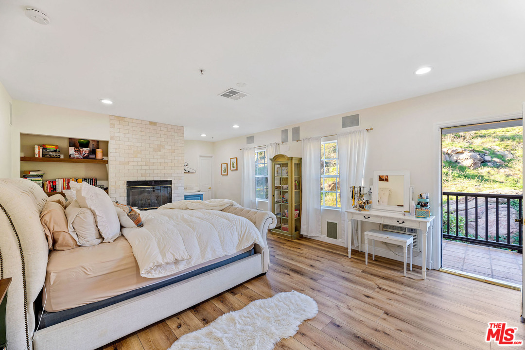 129 Saddlebow Road Bell Canyon, CA 91307 - Photo 27 of 39 a bedroom with a bed and a wooden floor