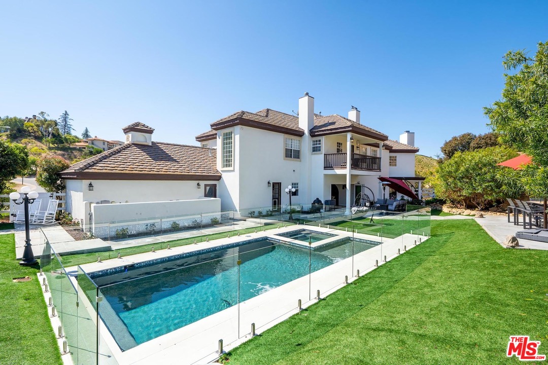 129 Saddlebow Road Bell Canyon, CA 91307 - Photo 37 of 39 a front view of a house with swimming pool having outdoor seating