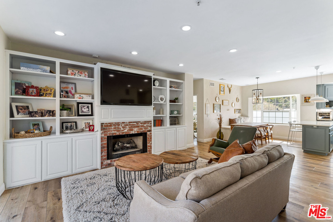 129 Saddlebow Road Bell Canyon, CA 91307 - Photo 10 of 39 a living room with furniture a fireplace a flat screen tv and rug
