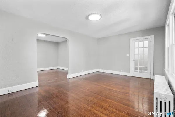 wooden floor in an empty room with a window