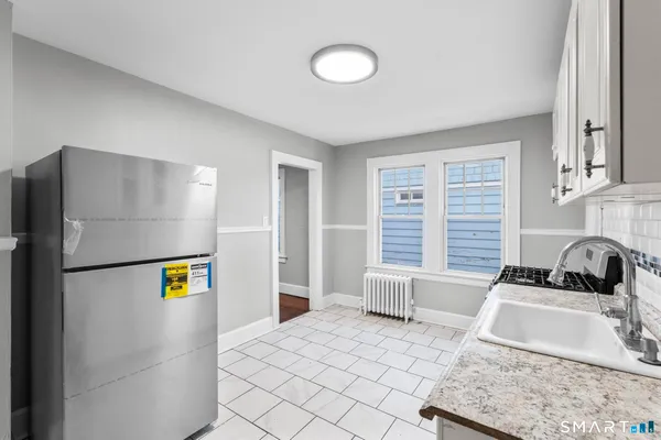 a kitchen with a refrigerator and a sink