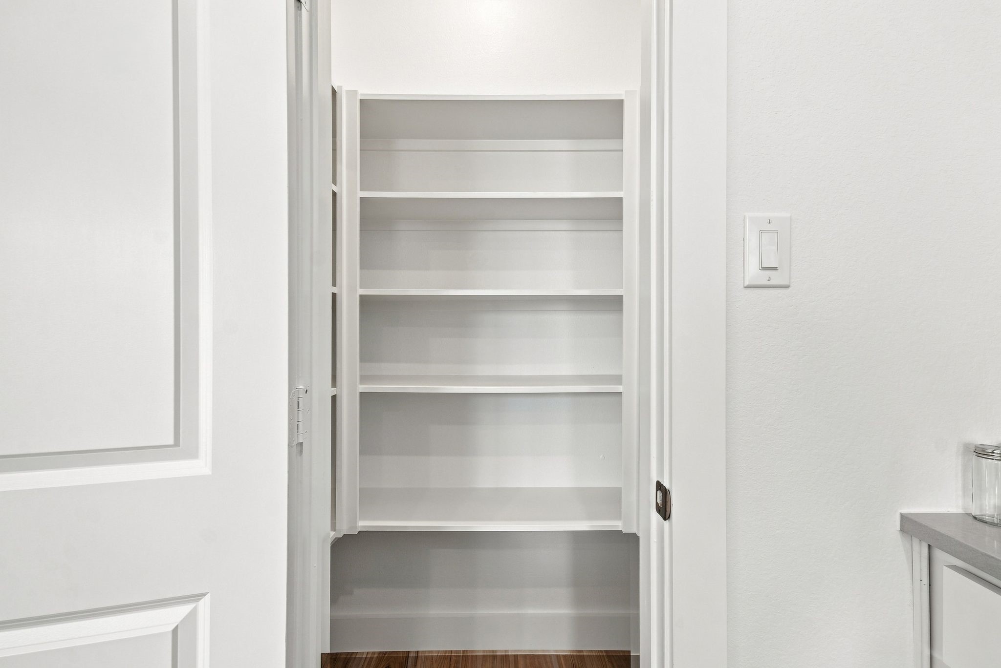 6057 Cebra Street Houston, TX 77091 - Photo 26 of 42 Convenient walk-in pantry with built-in shelving providing generous storage adjacent to the kitchen. Photos are from a different property with a similar floor plan. Finishes, features, and orientation may vary.