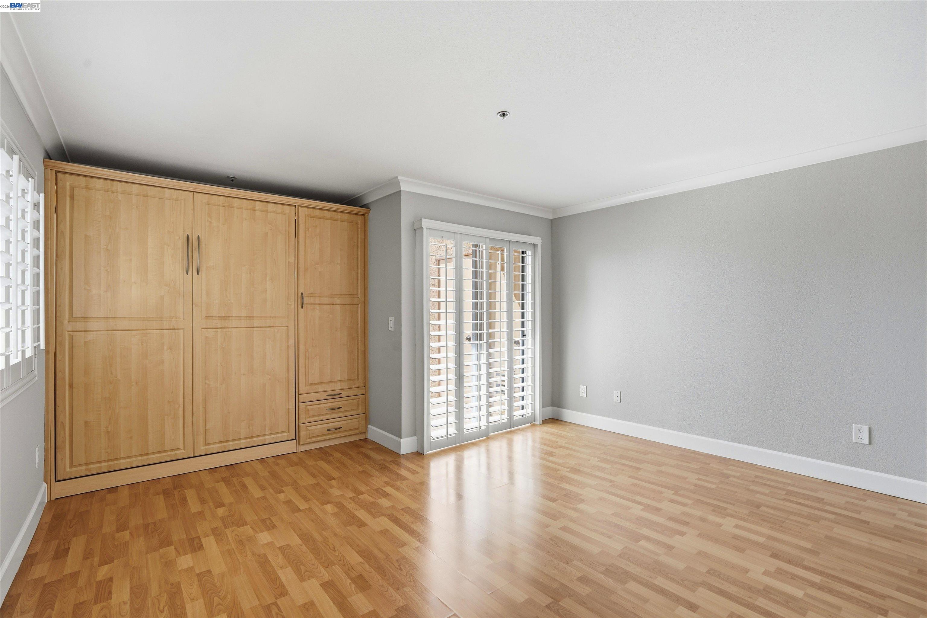 735 Watson Canyon Court, Unit 218 San Ramon, CA 94582 - Photo 9 of 18 an empty room with wooden floor and windows