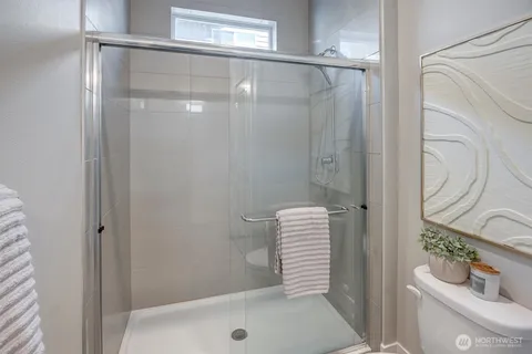a bathroom with a shower and a toilet