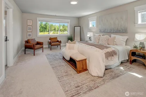 a spacious bedroom with a bed a couch and a window