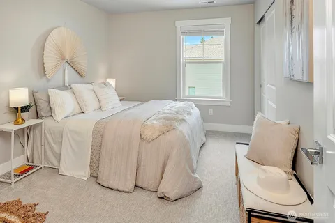 a bed room with a bed and chair