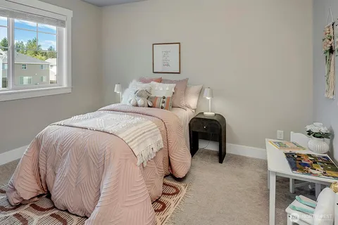 a bed sitting in a bedroom next to a window