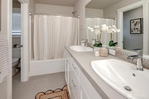 a bathroom with a sink a mirror and a shower