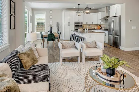 a living room with furniture and a chandelier