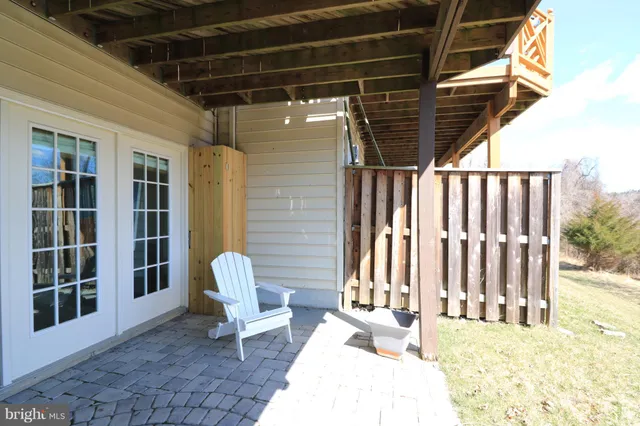 a living room with wooden floor and stairs