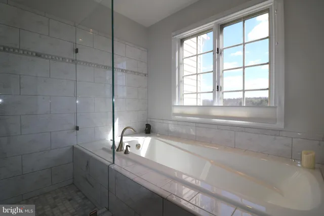 a bathroom with a double vanity sink mirror and shower