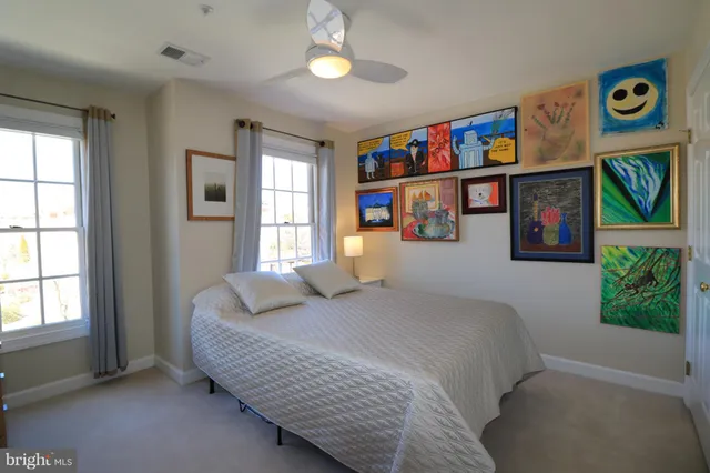 a bedroom with furniture and a book shelf