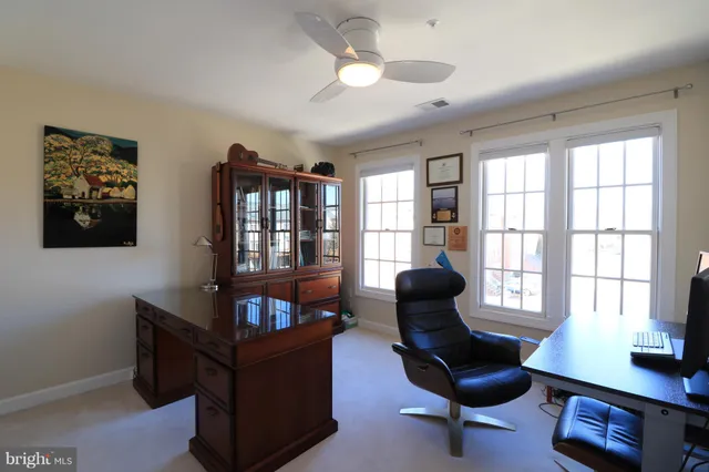 a living room with furniture cabinets and potted plant