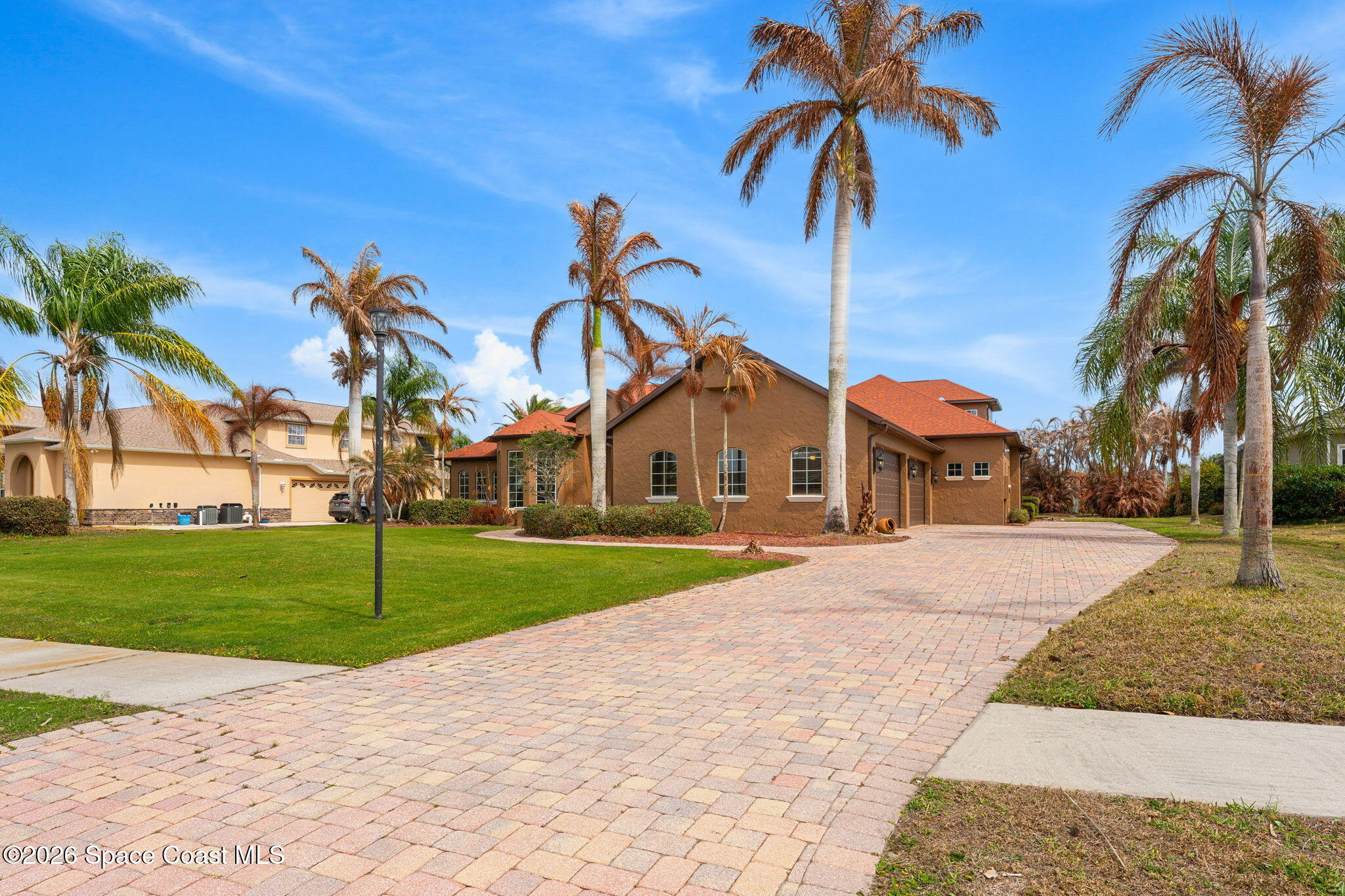 5137 Royal Paddock Way Merritt Island, FL 32953 - Photo 101 of 132 a front view of a house with a yard and garage