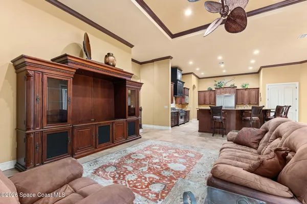 a kitchen with stainless steel appliances kitchen island granite countertop a table and chairs in it