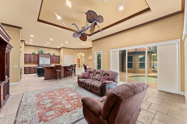 a living room with lots of furniture and kitchen view