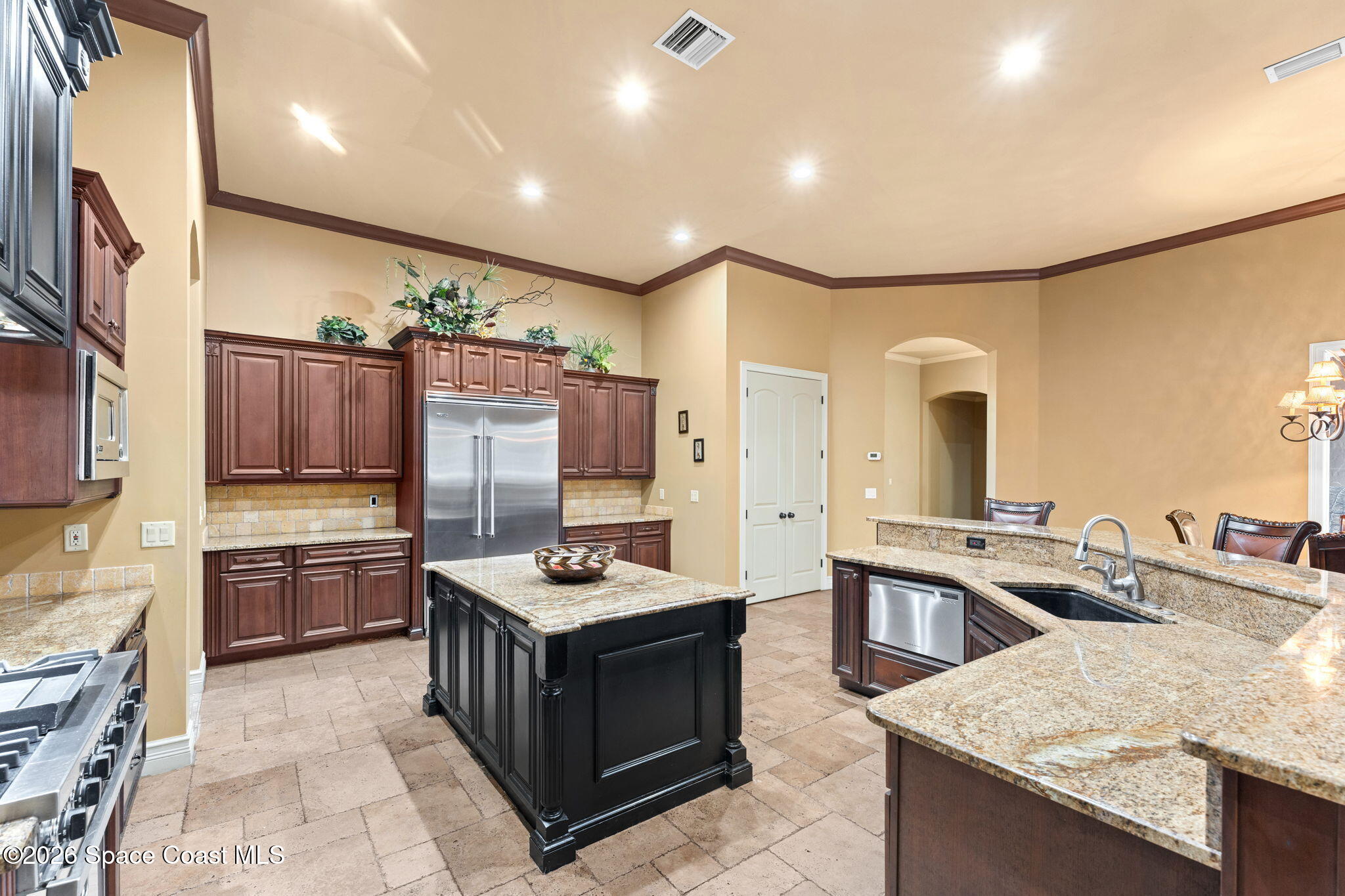 5137 Royal Paddock Way Merritt Island, FL 32953 - Photo 22 of 132 a kitchen with kitchen island granite countertop a sink stove and refrigerator