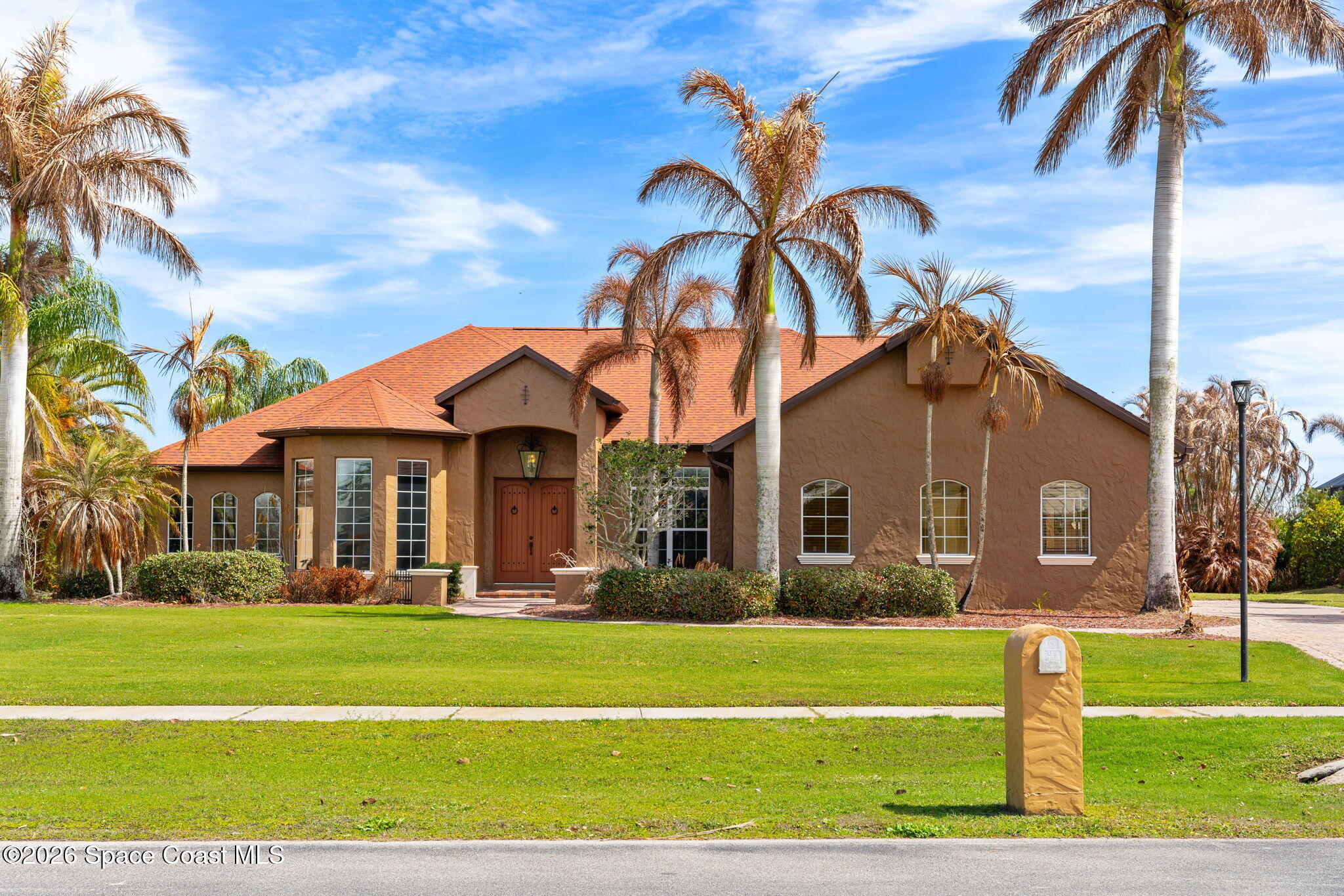 5137 Royal Paddock Way Merritt Island, FL 32953 - Photo 4 of 132 a front view of a house with a yard